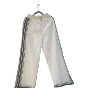 We’re all Pretty Girls Linen and Rayon wide leg white and navy stripped pants.